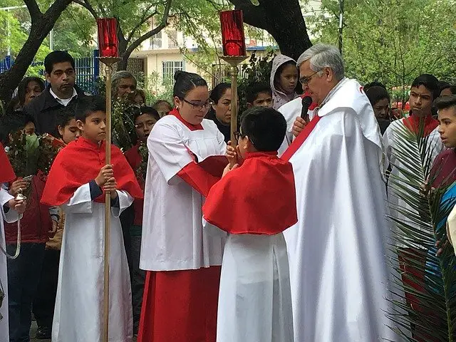 Priest and worshiper with palm frond 