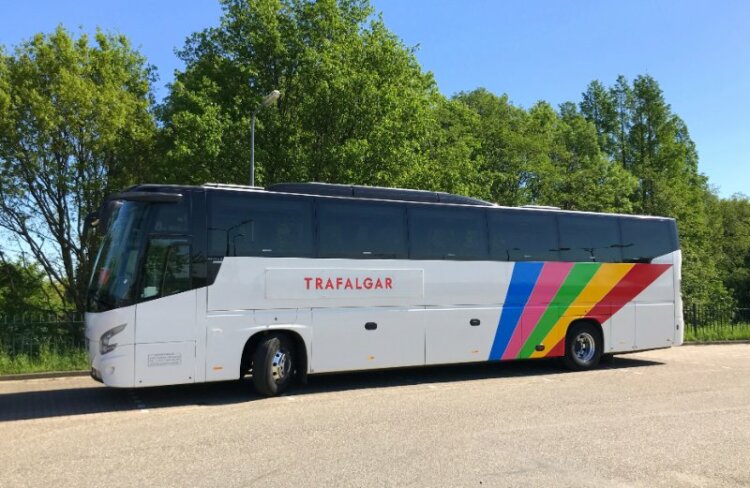 Trafalgar bus parked near a tree