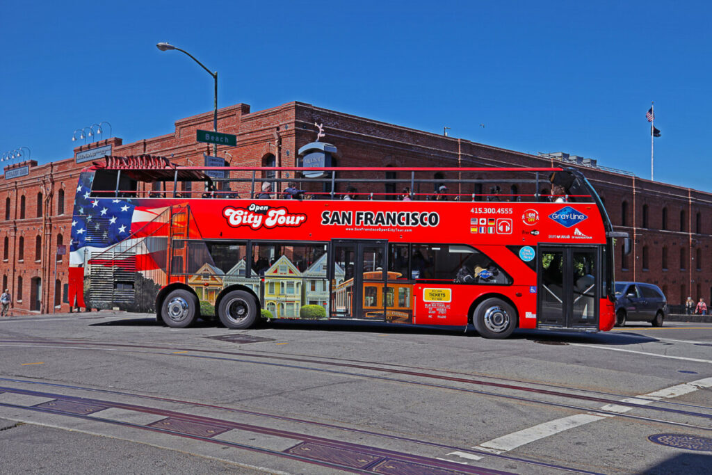 An Open City Tour open topped bus. The sightseeing bus tour operates in more than 100 cities globally, is taking tourists to the major landmarks.