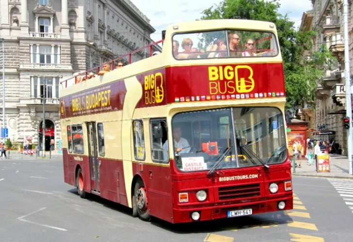 Big bus carrying tourist along the road