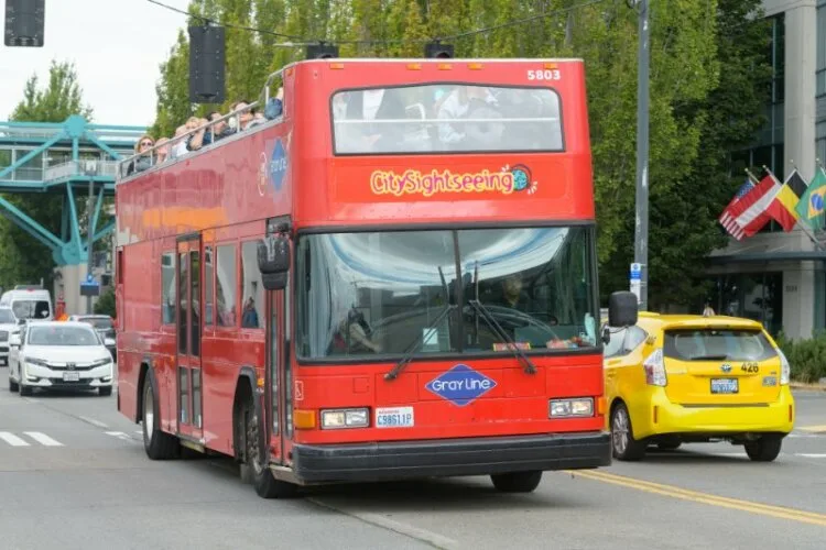 A City Sightseeing red double decker bus with tourist