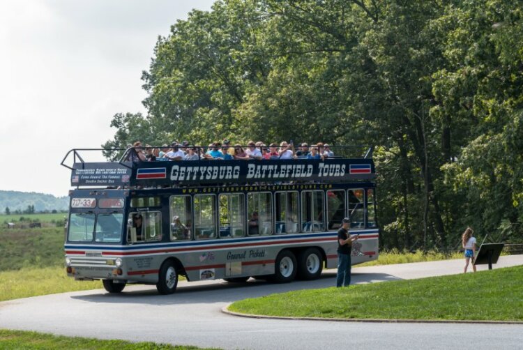 A filled double decker tour bus