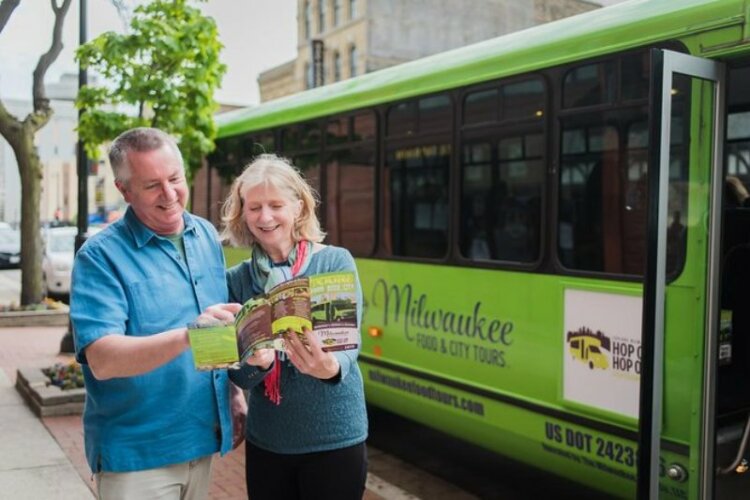 Man and women holding pamplet