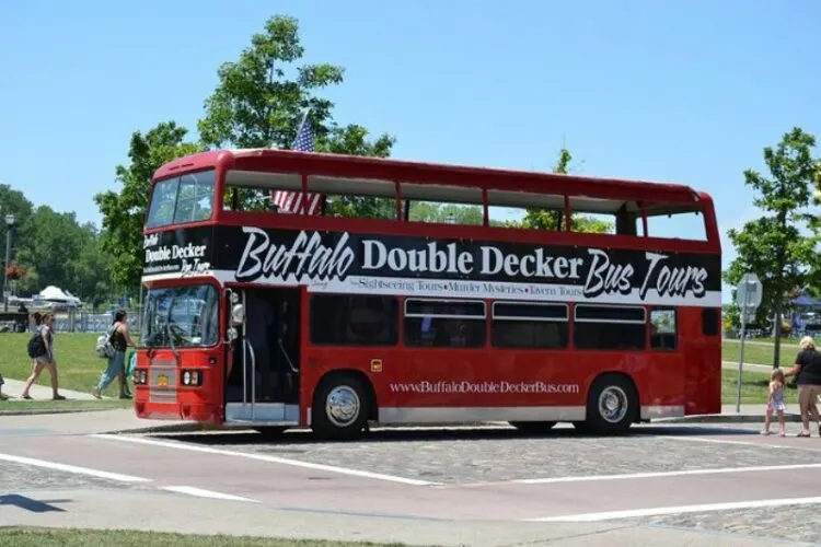 People walking 
 near Buffalo Double Decker Bus 