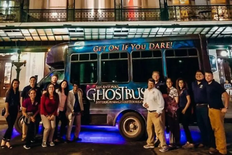 Tourist standing in front of Ghost tour bus