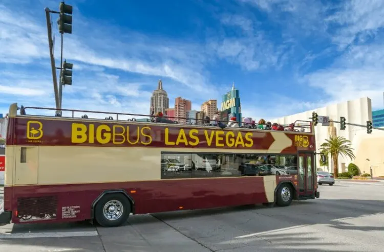 "hop on hop off" tourist sightseeing bus turning onto a street in Las Vegas