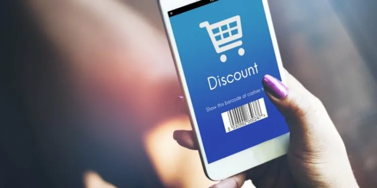 Girl holding a mobile phone with screen displaying the discount code 