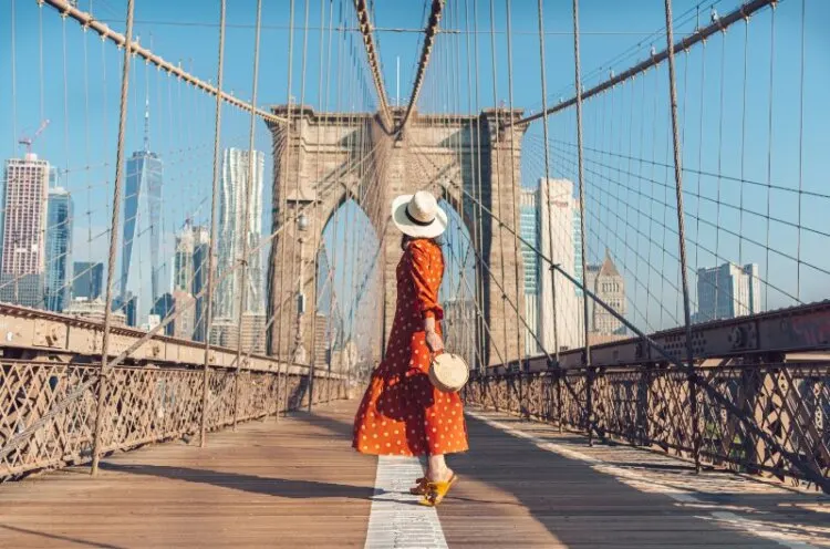 Young women standing on Brooklyn Bridge