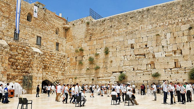 people gathered at the Jericho wall in Jerusalem