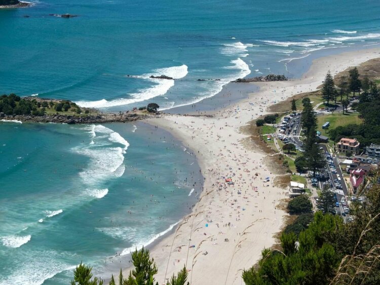 pristine blue sea view with tourists from the peak of Mount Maunganui