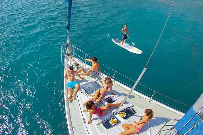people relaxing and lounging by the yacht at Playa Majahuitas
