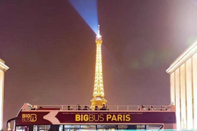 Eiffel tower backdrop at night during a Big Bus Paris Evening Tour