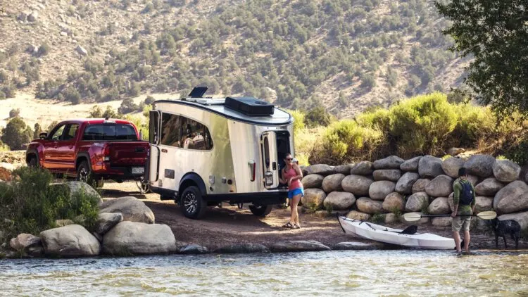 Couple in a River with their Airstream Trailer