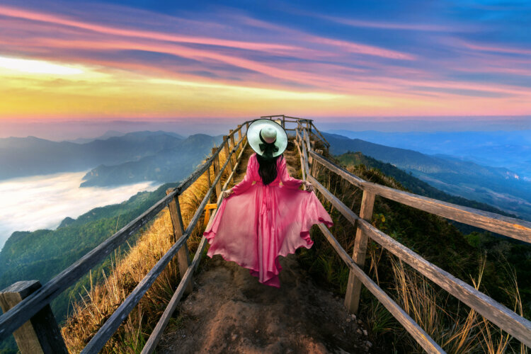 Beautiful girl running on Phu chi dao mountain at sunrise in Chiang Rai