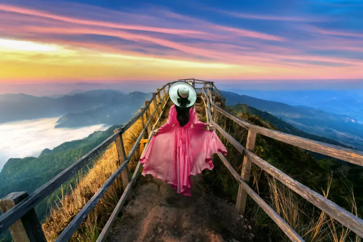 Beautiful girl running on Phu chi dao mountain at sunrise in Chiang Rai