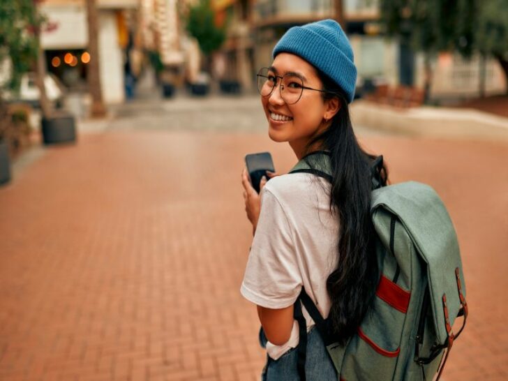 Asian woman with backpack smiling