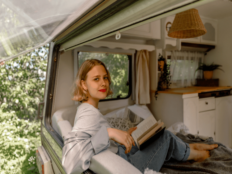 Woman reading a book inside motor home