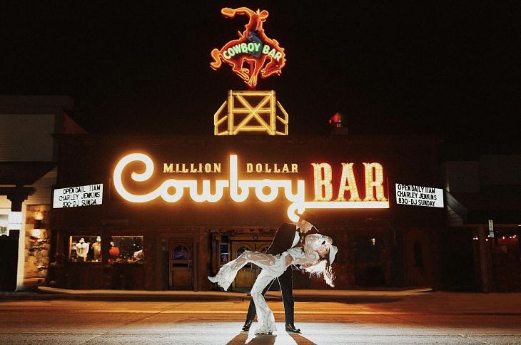 Prenup shoot of couple dancing outside the Million Dollar Cowboy Bar in Jackson