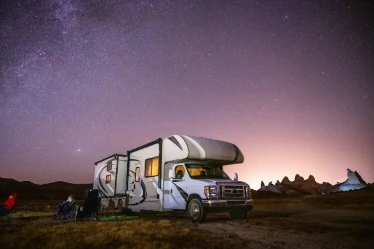 Camper stargazing from his motorhome trailer