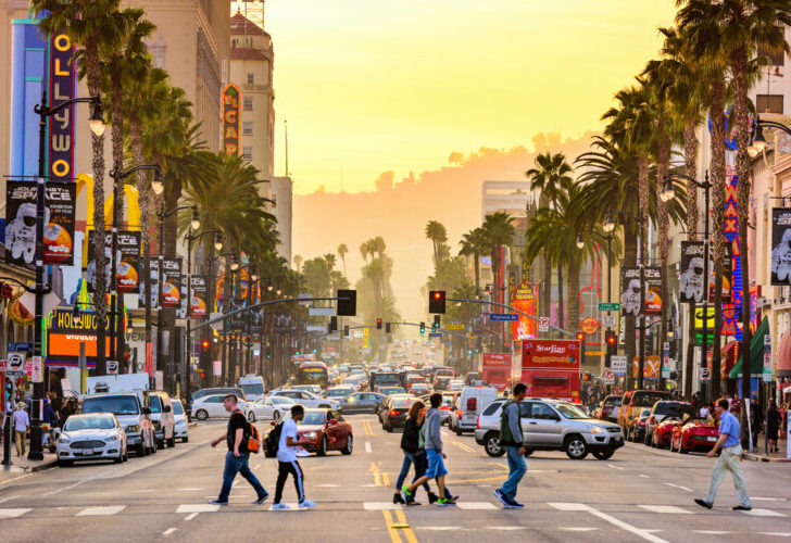 Traffic and pedestrians on Hollywood Boulevard at dusk