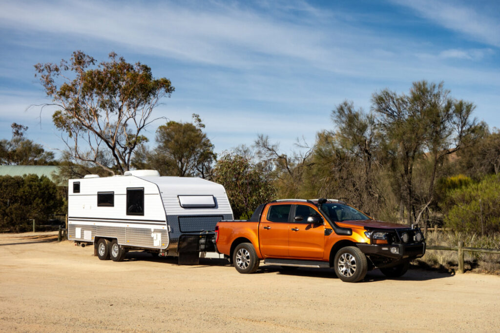Off road pickup car with air intakes and a white caravan trailer in Western Australia