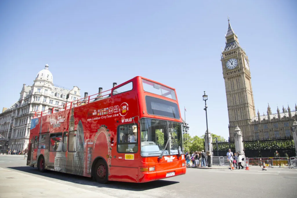 Open top site seeing City Tour bus passes Big Ben