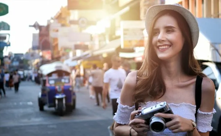Tourist with travel vlogging camera
