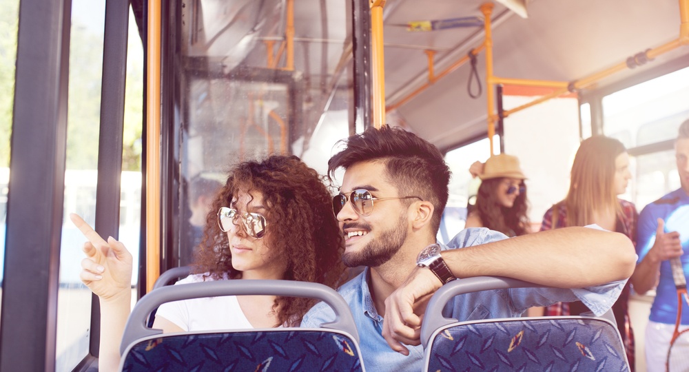 Smiling young couple in a bus