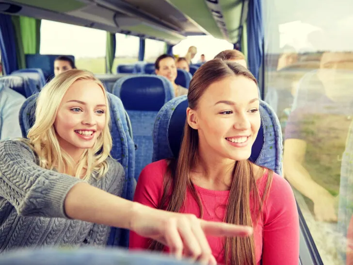 Young women or teenage friends riding in travel bus