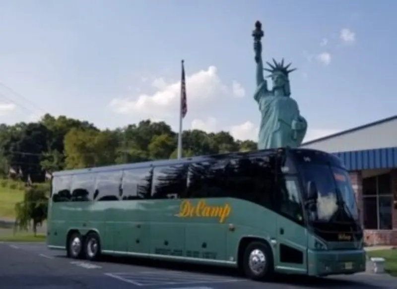 Decamp bus with the statue of liberty in the background