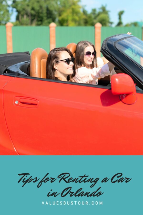 Two women driving around in red sports car