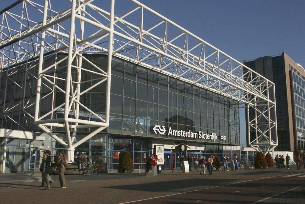 Amsterdam Sloterdijk Station features modern architecture, vibrant commuters, and a bike-friendly environment.