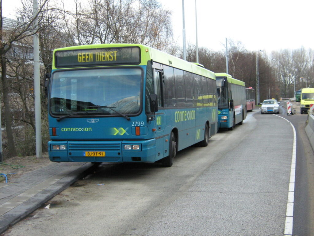 Buses parked on a cold day in an urban setting, highlighting public transportation options.