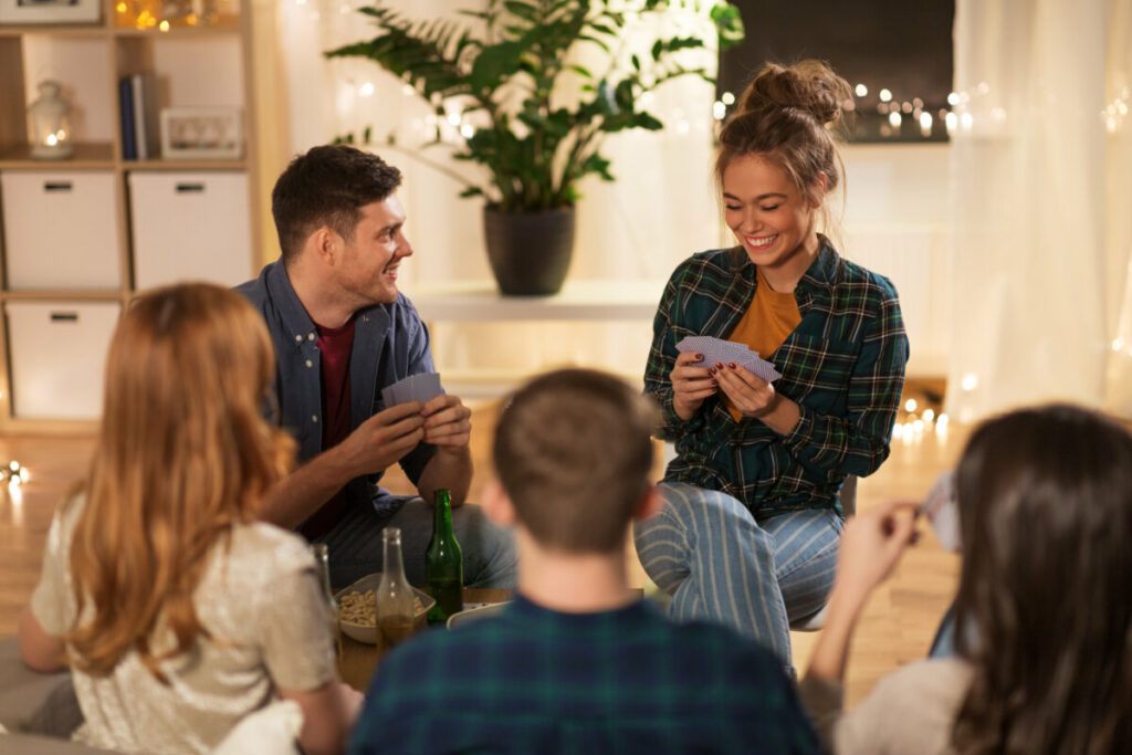 Friends playing a drinking game with cards
