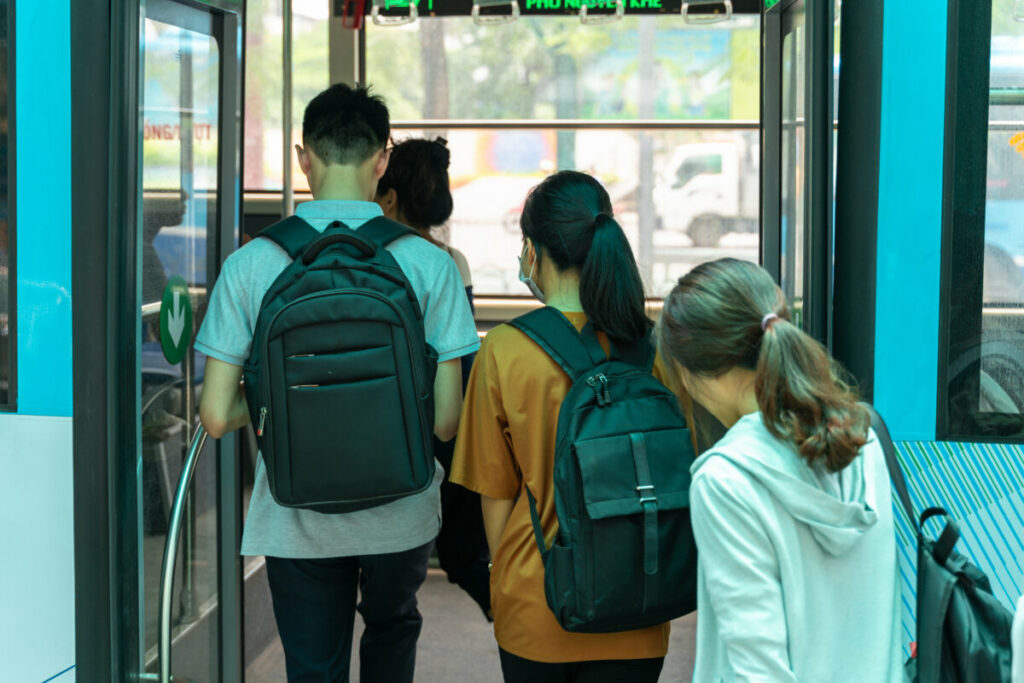 Group of people diverse in age getting on the bus