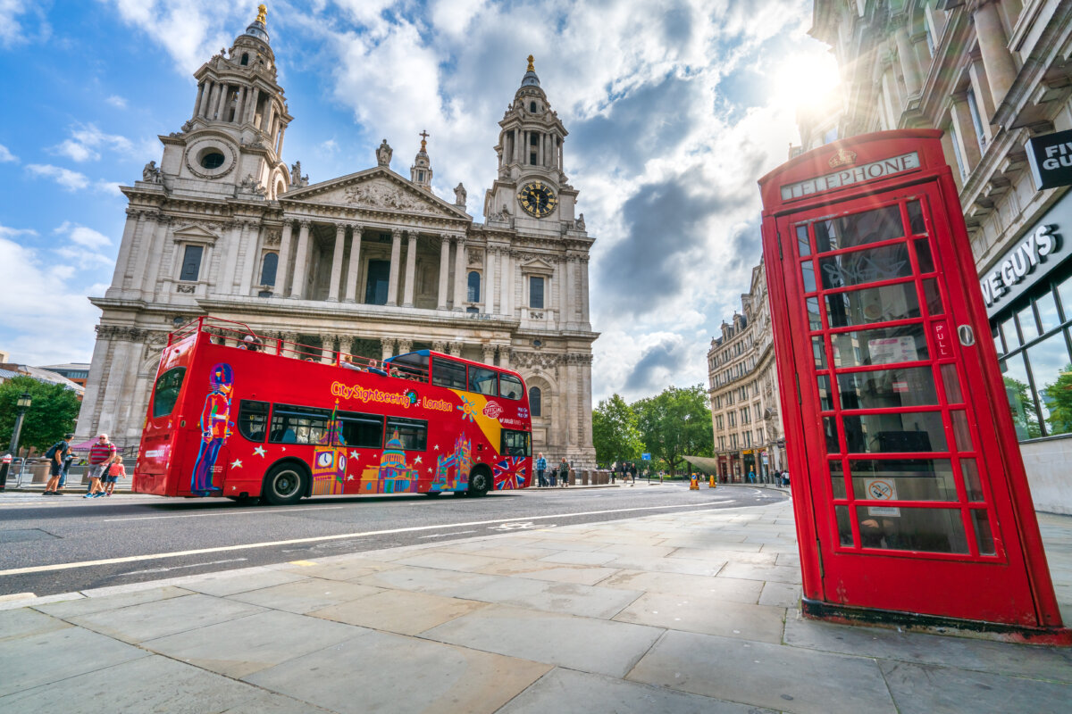 CitySightseeing Hop on Hop off red double decker tour bus in front of St. Paul's cathedral in London, England
