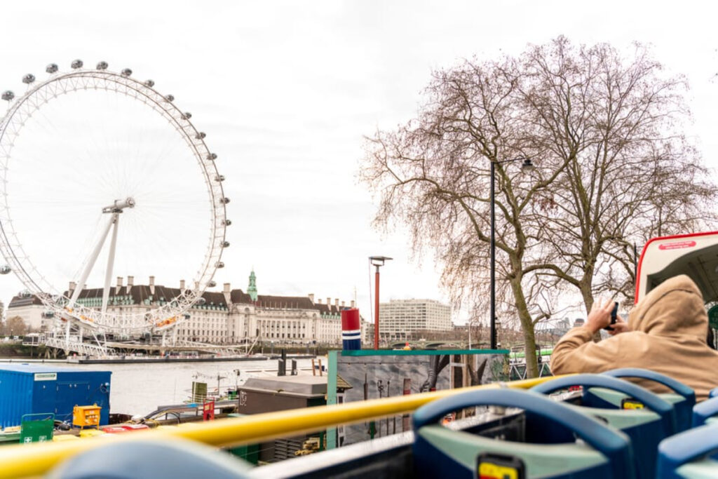 Tourists exploring and sightseeing London on a Tootbus tour bus