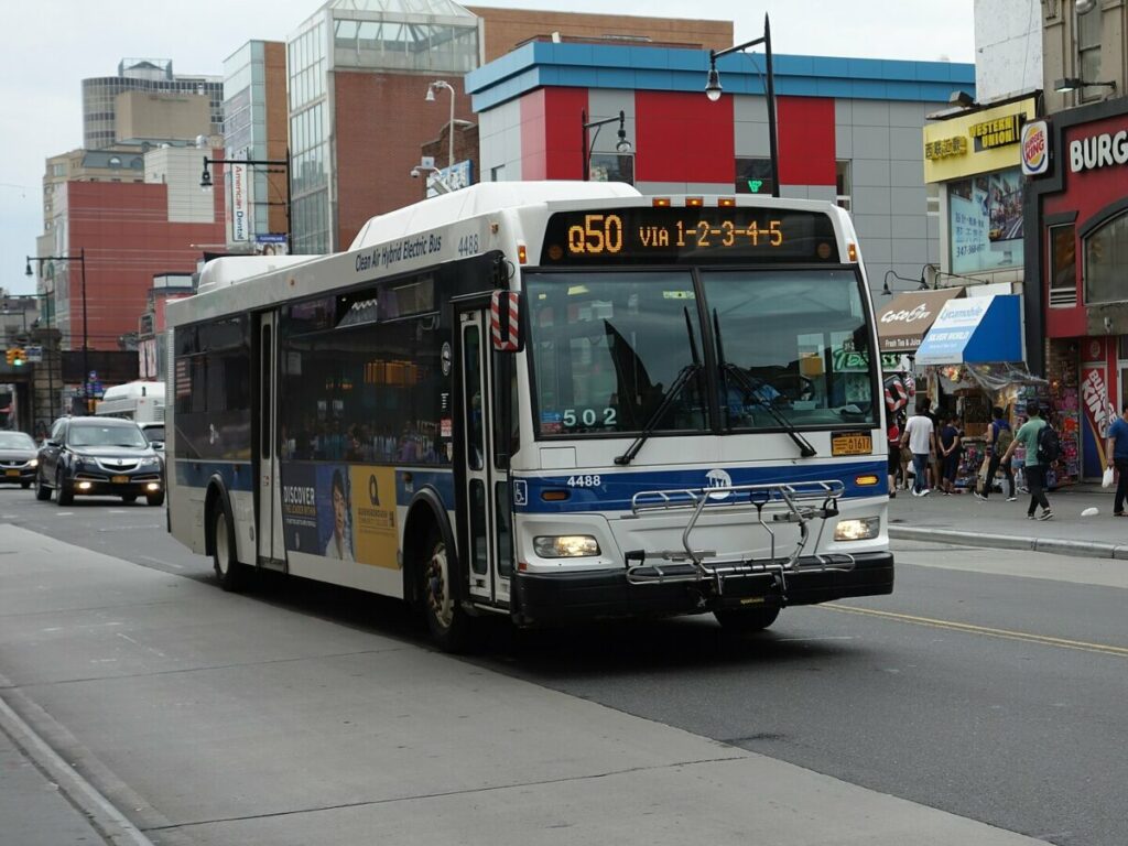 New York bus with a bike rack in front of the bus