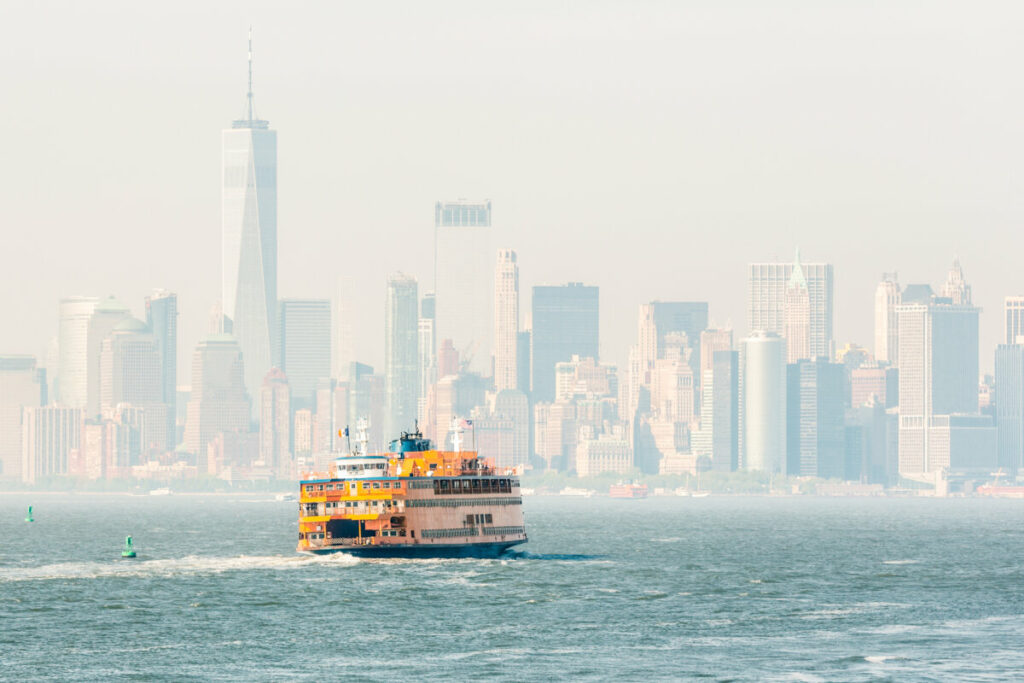 Staten Island Ferry and the panoramic view of Lower Manhattan Skyline in New York City