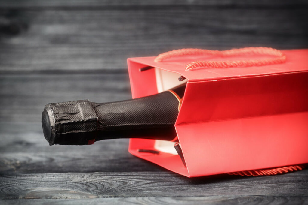 Close-up of a wine inside a red gift bag